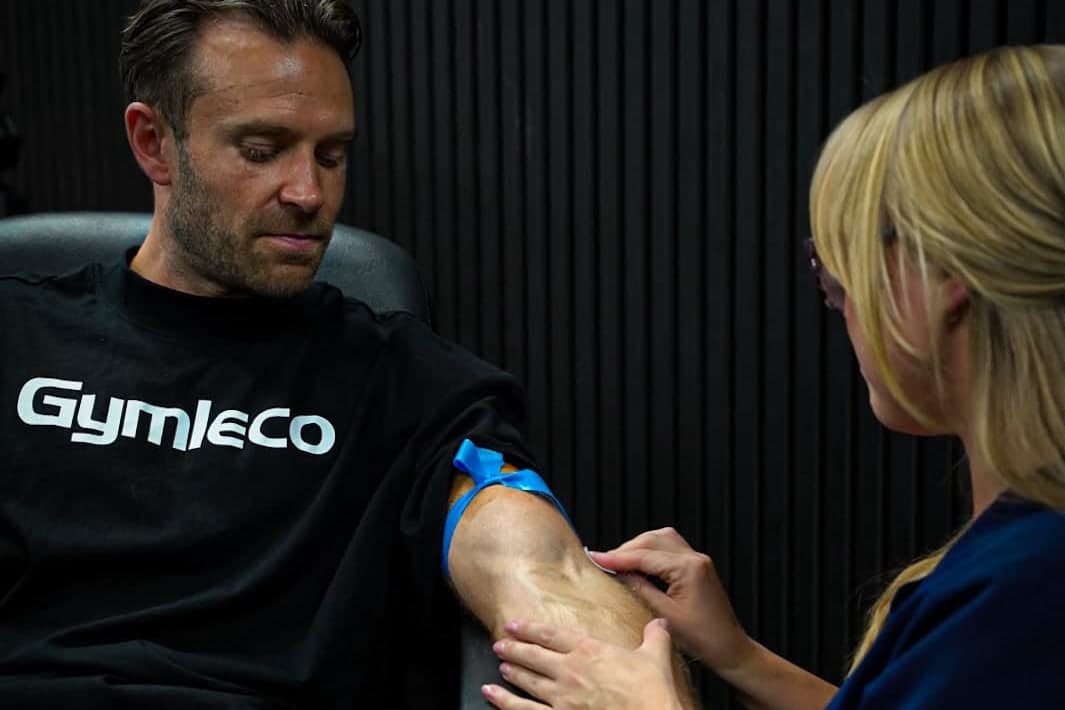 Jemma, our phlebotomist, taking a blood sample from a client's arm